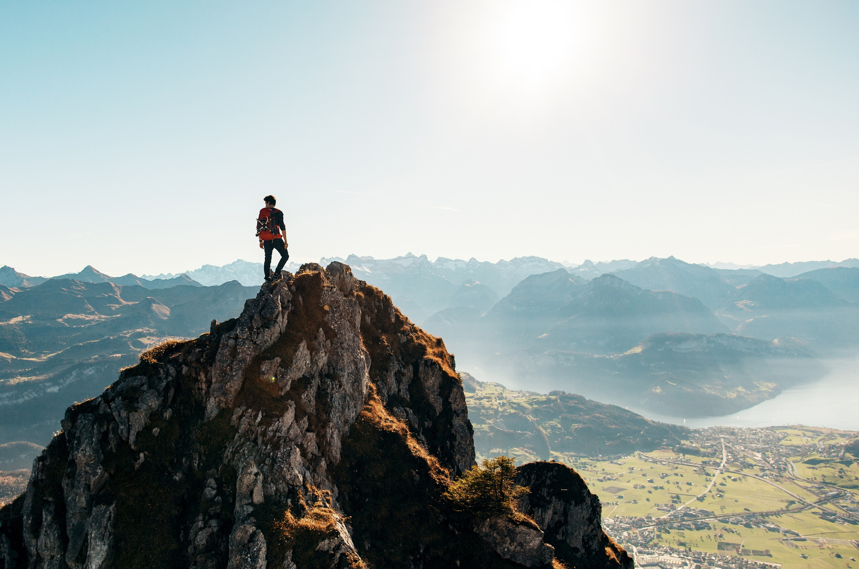 Man Standing on Top of a Rocky Mountain